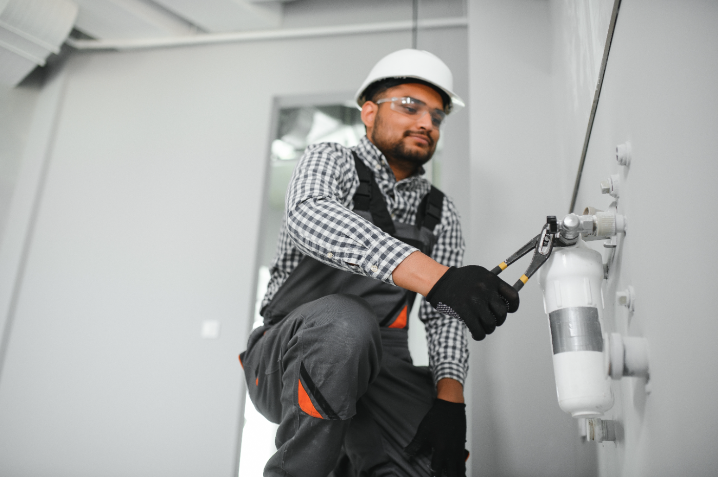 Licensed plumber tightening a manifold valve during a slab leak repair in Murrieta, CA